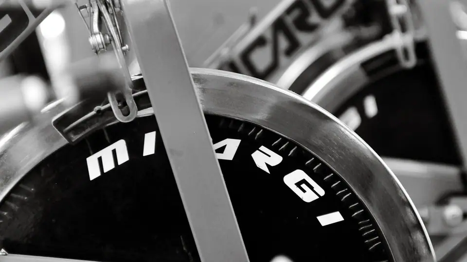 Black-and-white close-up of an indoor cycling bike flywheel