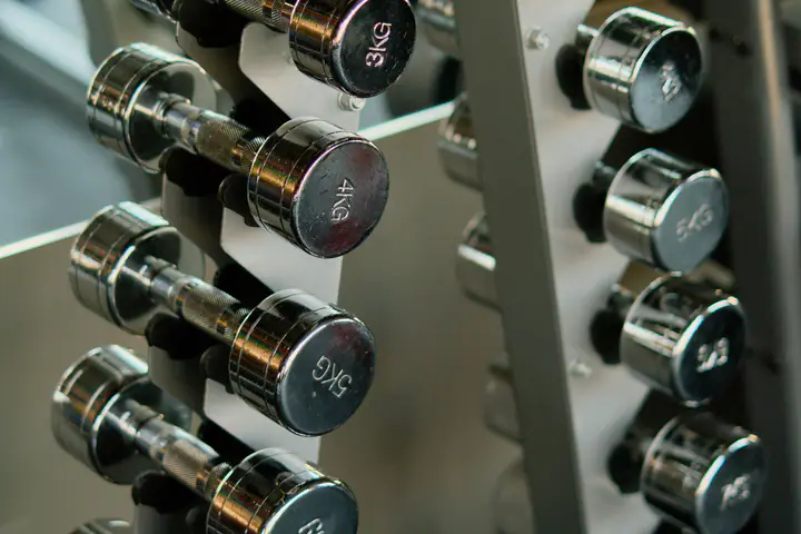 Chrome dumbbells in ascending weights on a vertical rack