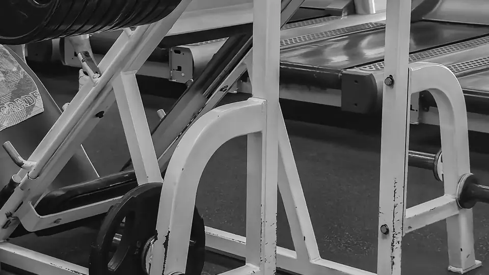 Black-and-white photo of a plate-loaded leg press machine