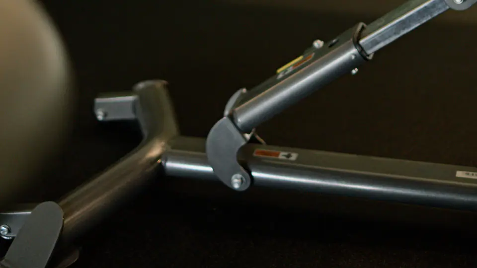 Back extension bench with padded supports in a gym corner