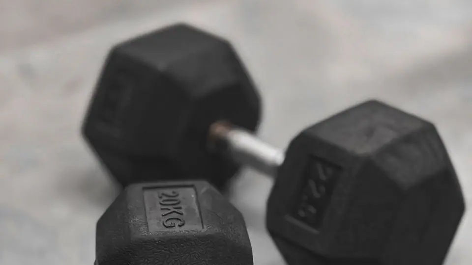 Pair of hexagonal dumbbells on a concrete floor
