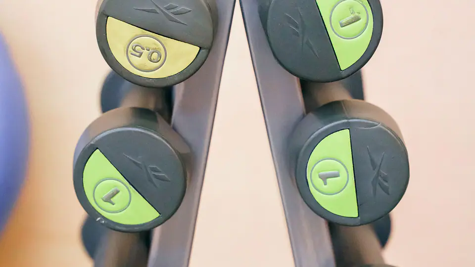 Light dumbbells arranged on an A-frame stand