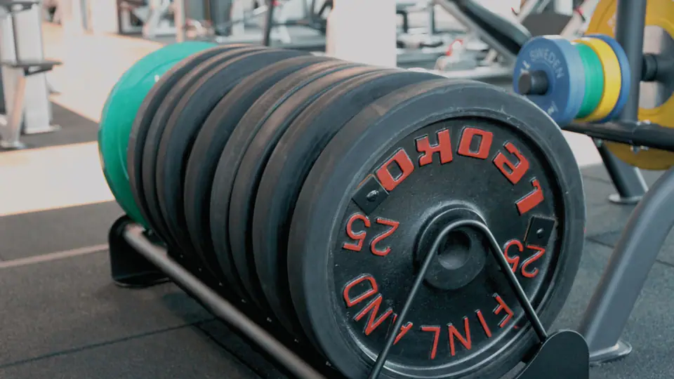 Stack of competition bumper plates on a storage rack